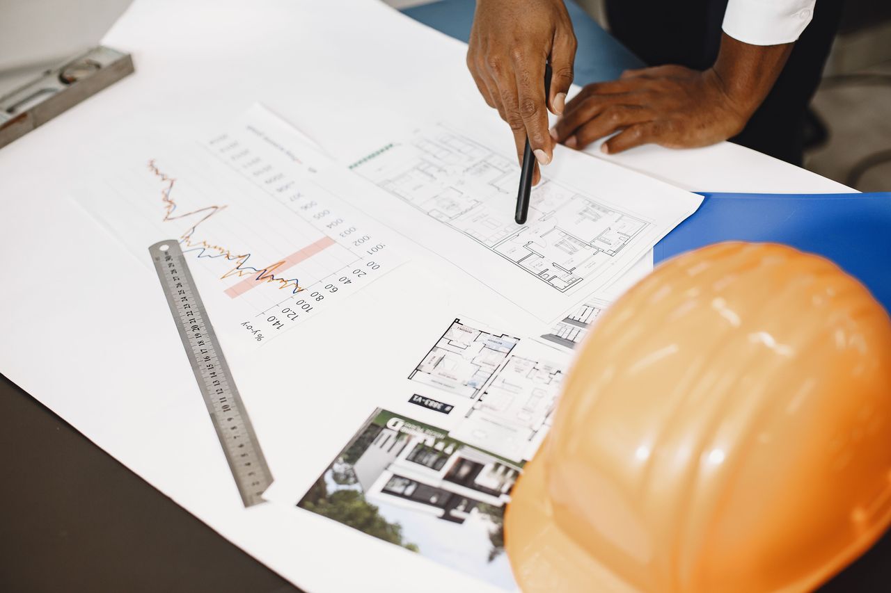 Construction plans and hard hat for planning repair work