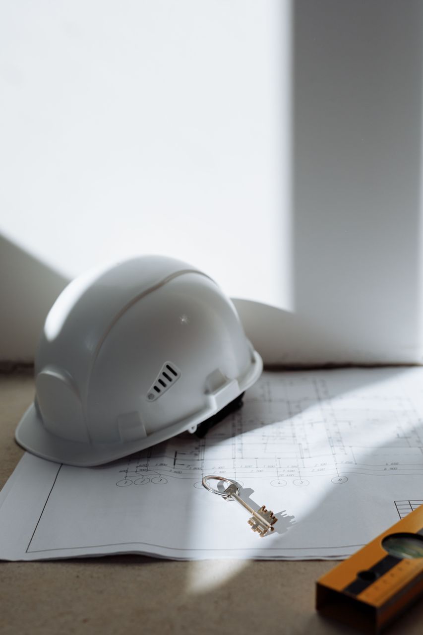 Hard hat and construction plans for permit review