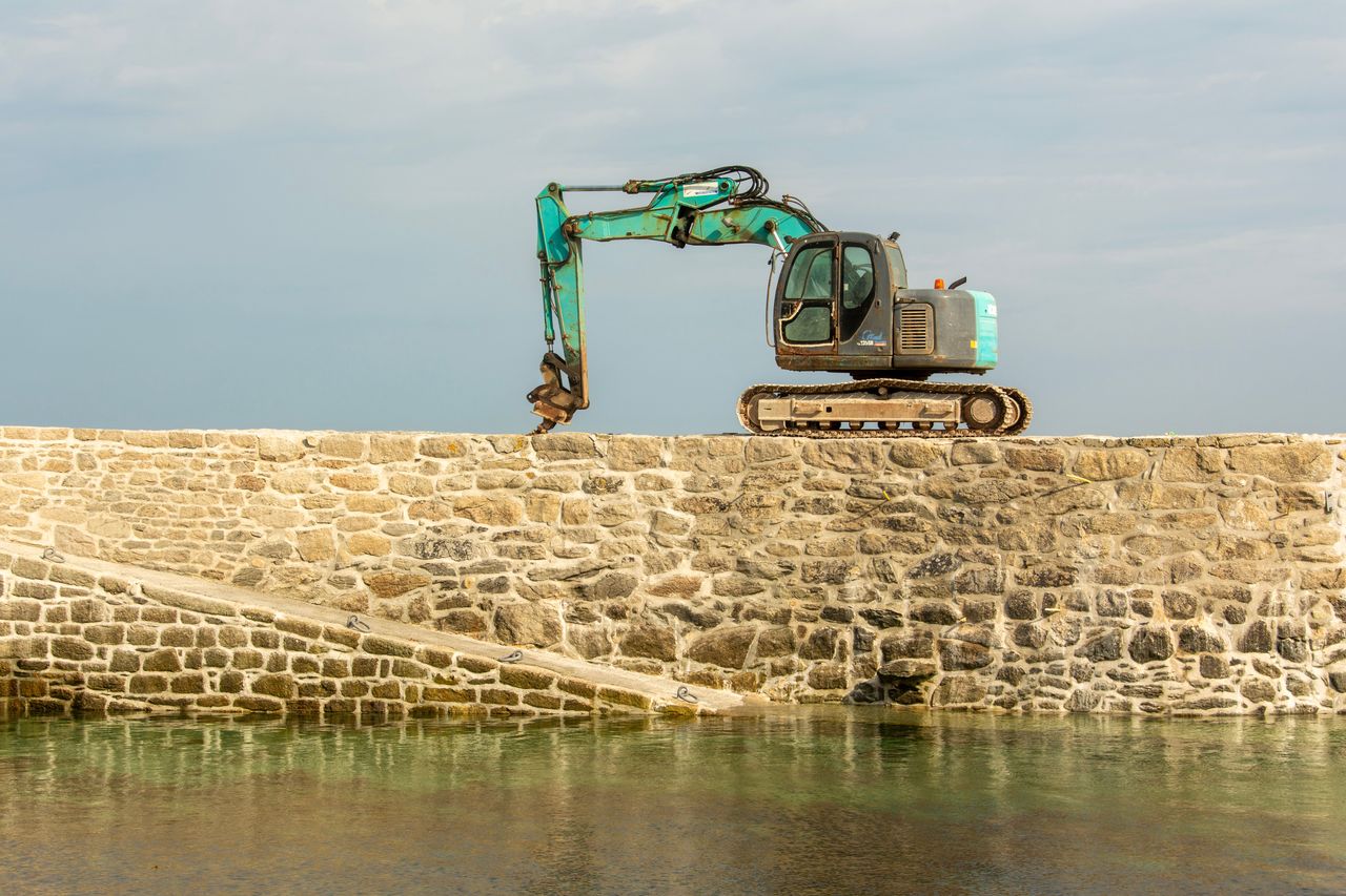 Excavator on a seawall during replacement work